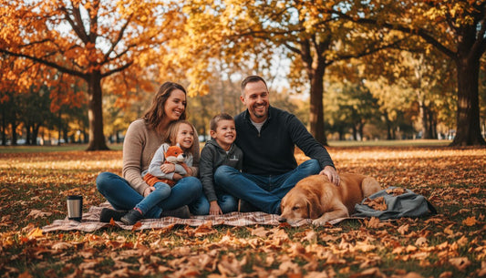 Family posing on blanket in autumn park